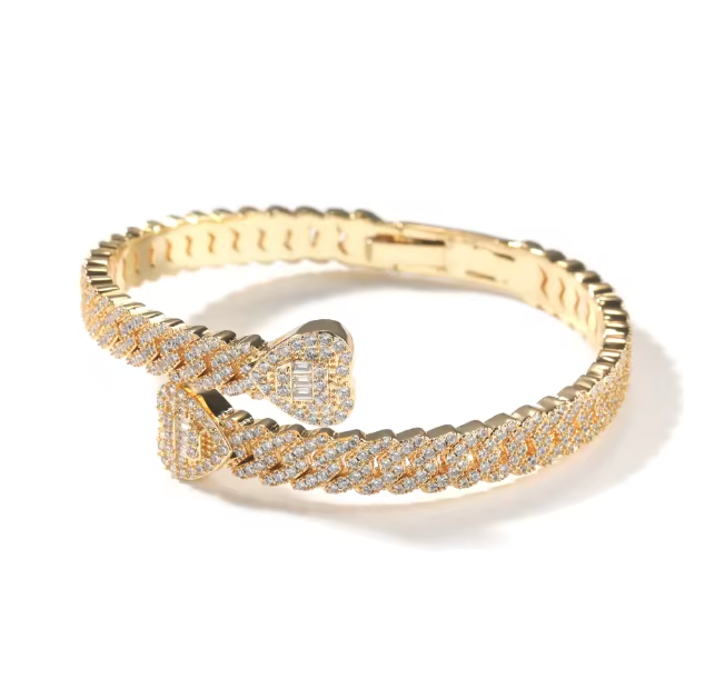 Gold bracelet with diamond accents on a white background