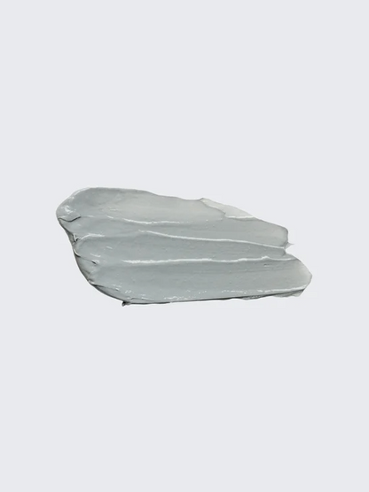 Two smears of light gray cream on a white background
