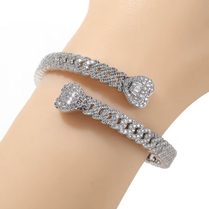 Silver bracelet with diamond-like stones on a mannequin arm against a white background