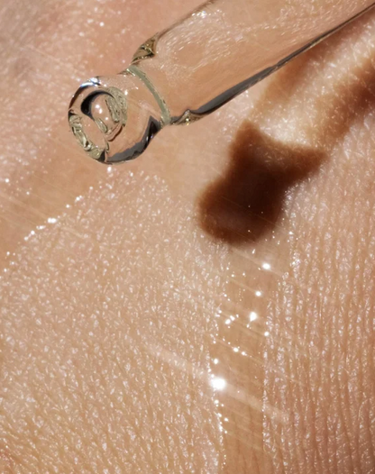 Close-up of a droplet on skin with a small object near it