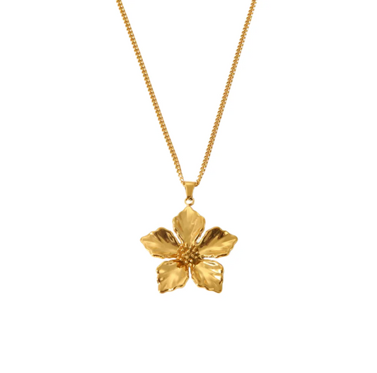 Gold flower pendant necklace on a white background