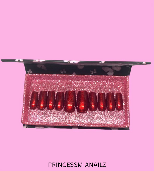 Enchanting red press-on nails in a glittering pink box from PrincessMiaNailz, the brand that transforms nails into royal perfection with ease.